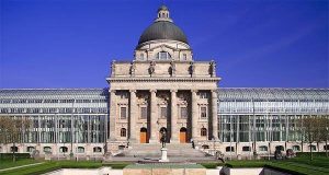 German Government WASCAL Scholarship 2025 | Fully Funded for Africans A neoclassical building with a large dome, columns, and glass extensions on both sides stands proudly against a clear blue sky—an inspiring setting often associated with the prestigious German Government WASCAL Scholarship.