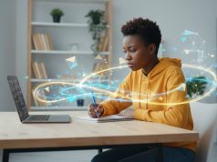 How to write a Scholarship Essay: Tips & Examples for African Students A person in a yellow hoodie works at a desk with a laptop and notebook, surrounded by digital, glowing geometric graphics—perfectly capturing the focus needed to master scholarship essay examples for African students.