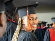 MBA Scholarships for Minorities: 15 Fully Funded Opportunities in 2026 A graduate smiling confidently in cap and gown, celebrating their academic achievement at a graduation ceremony, representing the success of minority students pursuing MBA scholarships.