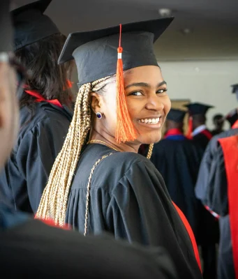 MBA Scholarships for Minorities: 15 Fully Funded Opportunities in 2026 A graduate smiling confidently in cap and gown, celebrating their academic achievement at a graduation ceremony, representing the success of minority students pursuing MBA scholarships.