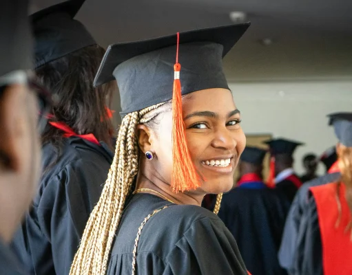 MBA Scholarships for Minorities: 15 Fully Funded Opportunities in 2026 A graduate smiling confidently in cap and gown, celebrating their academic achievement at a graduation ceremony, representing the success of minority students pursuing MBA scholarships.