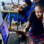 Young African professionals collaborating on digital skills training